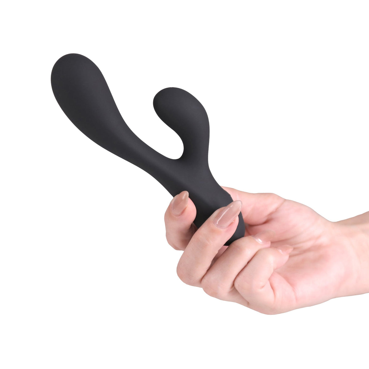 A matte black silicone dual-stimulation personal massager being held by a hand against a solid white background.
