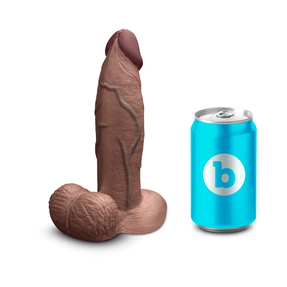 b vibe slipskin girthy sliding skin silicone dildo in chocolate, from the side next to a soft drintkcan for size reference