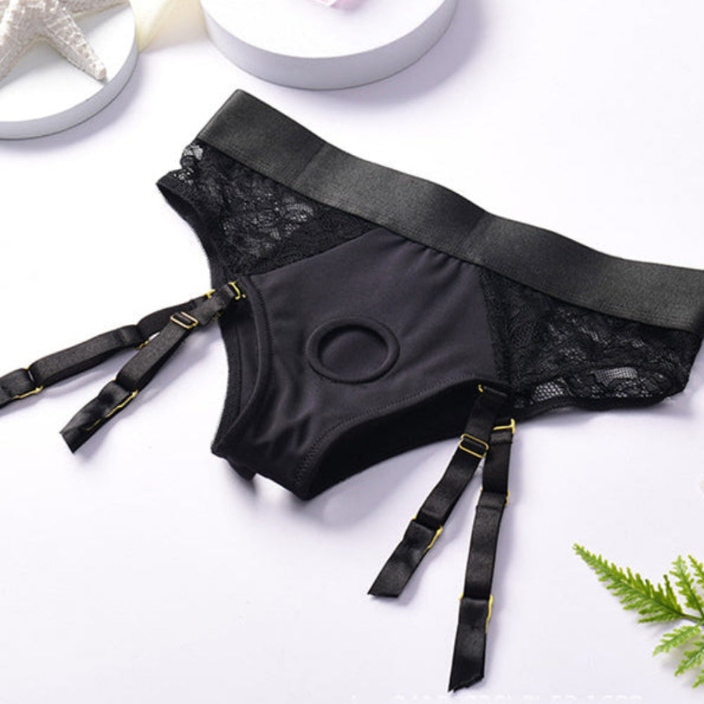 Crotchless open back lave panty harness with removable garter straps laid flat form the front