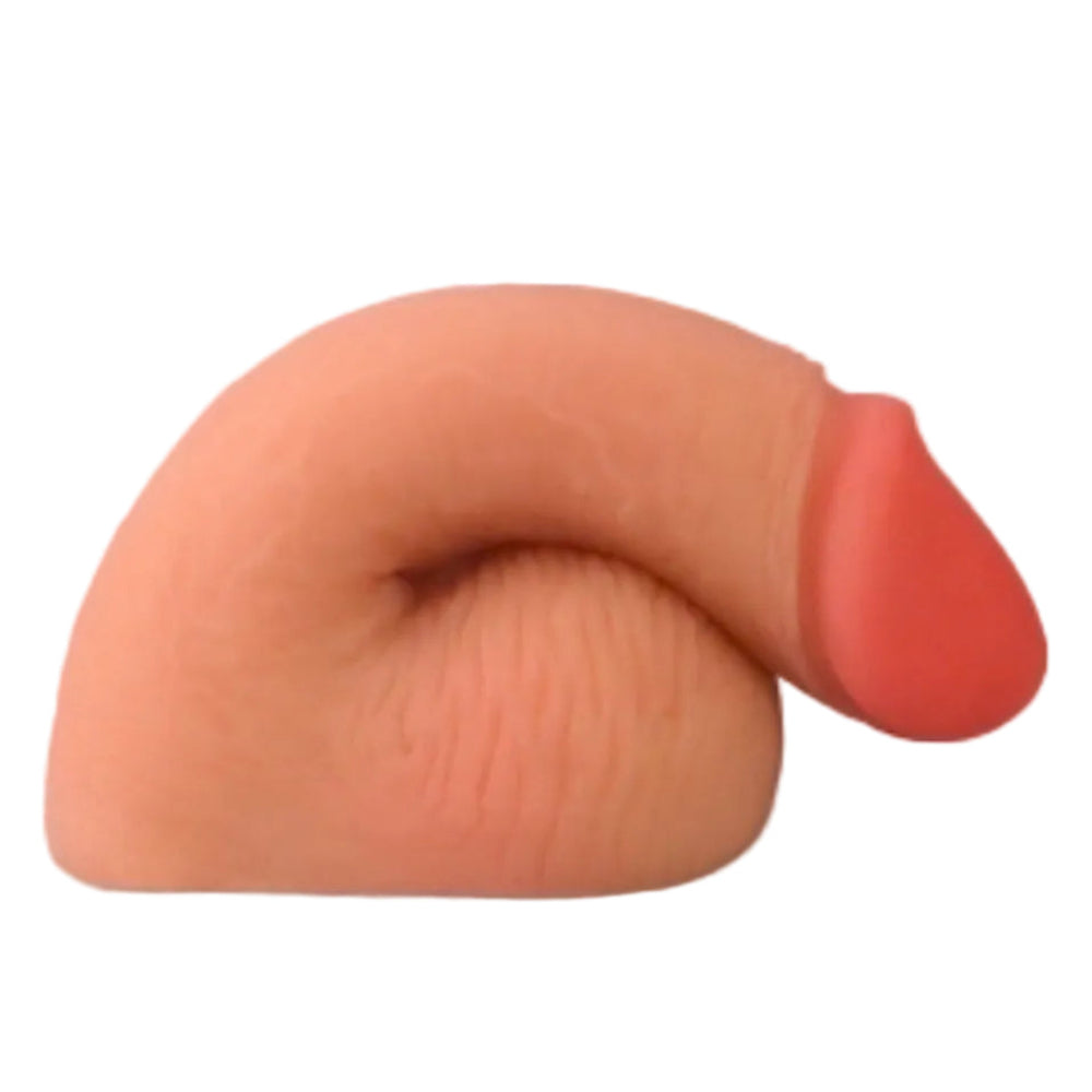 Love toy 5.5 inch dual layer TPE packing penis from the side in a flaccid position