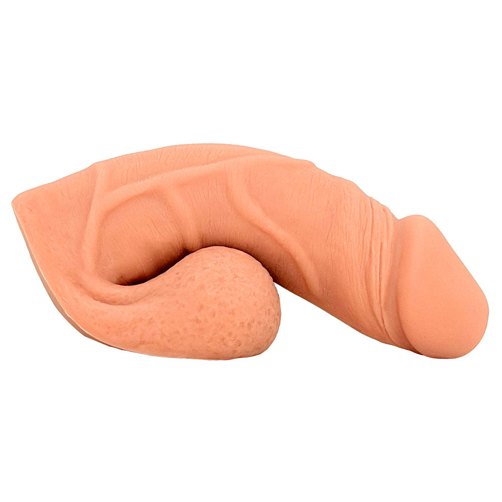 Freeform Medium 5 inch silicone soft  ftm packer, in warm rosy color from the side, sitting on the balls as a base