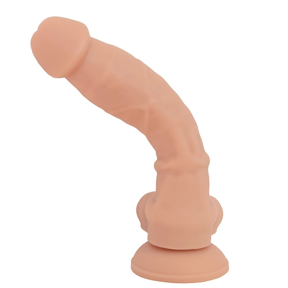 Nexus Silicone Stance dual density posable vanilla dildo, flat on its suction cup base from the back, and bent over to the left